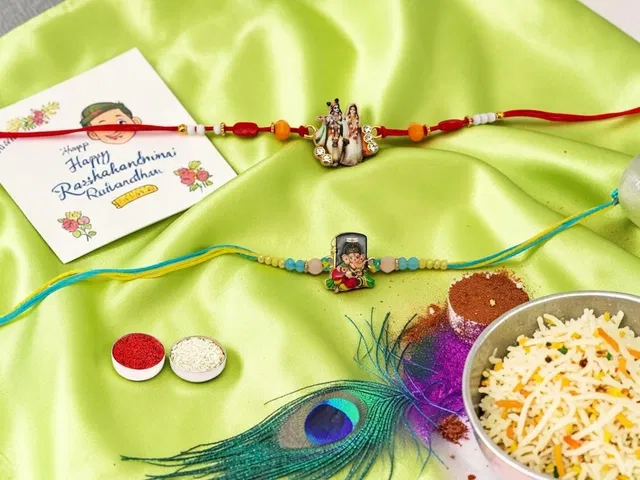Metal Radha Krishna Ganes Ji Rakhi (Multicolor, Pack of 2)