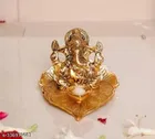 Metal Ganesh Idol Sitting On Leaf 