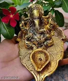 Metal Ganesh Idol Sitting On Leaf 